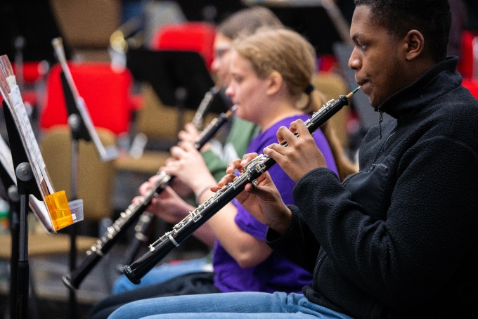 Students in attend a band rehearsal led by Jon Nelson, director of the UB Concert Band, in Baird Hall.