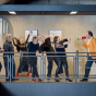 Neue Vocalsolisten Stuttgart pictured on a subway platform. 