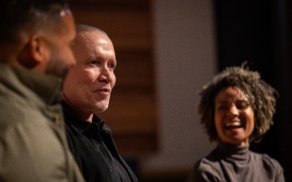 Michael Abels (center), an American composer, speaks with prof. Melissa White (right) and Marshall Lindsey (left), on the stage in the Baird Hall Recital Hall. 