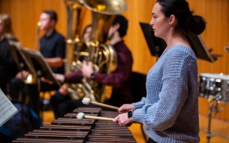 Devin Zimmer, piano technician, works with the Department of Music's new B&ouml;sendorfer piano in Slee Hall in February 2024. Photographer: Douglas Levere. 