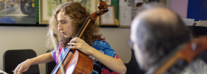 Jonathan Golove, with the department of music, teaches a student in a one-on-one cello lesson. 