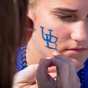 A student gets an interlocking "UB" painted on her face. 