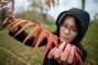 Trang Le examines a a staghorn sumac tree. 