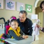 Yuna flashes a big smile as she plays with her father, Jae Lee, and mother, Soo-Kyung Lee (right). Soo-Kyung and Jae are biology researchers at the University at Buffalo. 