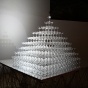 "Tide" is a pyramid of champagne glasses that gradually fill with water over the course of the exhibition, fed by a slow-dripping tube attached high above the uppermost glass. 