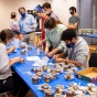 David Hoekstra (center, light blue shirt), clinical assistant professor and UB Bees director, and students gather to jar honey. 