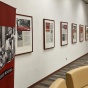 The "Open Wounds" exhibit in Abbott Library, with a half-dozen framed panels featuring photos and text displayed on a wall. 