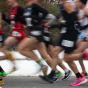 Blurred image of cross-country runners. 