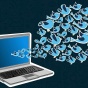 Flock of Twitter birds fly from a laptop. 