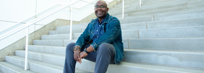 Donte McFadden, Director Distinguished Visiting Scholars portrait sitting on stairs. 