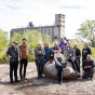 Dara Friedman (seated on the rock in the center of the group) and her students pictured together at the site of the labyrinth at Silo City. 