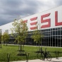 The TESLA logo, prominently displayed on a building. 