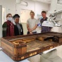 Pictured with the piano at the Canon Stroke and Vascular Research Center are graduate students Emily Vanderbilt and Martina Orji; William Fryburger, an apprentice to piano technician Devin Zimmer; and Zimmer. 