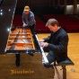 Eric Huebner plays the Department of Music's new Bösendorfer piano while Devin Zimmer observes in an empty auditorium. 