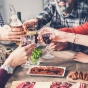 A family shares a toast during a meal. 