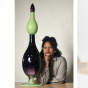 Left to right: Black Star Line (2024), blown glass created with the Museum of Glass; Crystal Z Campbell pictured with one of her blown glass works; and The Comet (after W.E.B. Du Bois) (2024). 