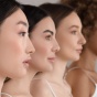 Four women in profile, focus on their chins. 