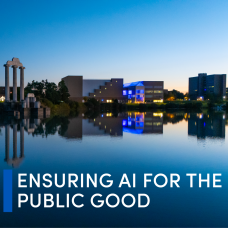 A wide, panoramic dusk photograph of a calm lake reflecting the University at Buffalo&rsquo;s North Campus buildings. In the center-left of the image, a classical stone structure with tall columns (Baird Point) stands on a small platform in the water. Its reflection is clearly visible in the still lake below. Trees line the shoreline behind it. Across the middle and right side of the image, several modern campus buildings are visible. One building glows with bright blue lighting, which is also reflected in the water. Other buildings have warm interior lights visible through windows. The sky transitions from deep blue at the top to lighter tones near the horizon, indicating early evening. In the lower right portion of the image, large white uppercase text reads: &ldquo;ENSURING AI FOR THE PUBLIC GOOD&rdquo; To the left of this text is a vertical blue bar. The overall scene is serene and symmetrical, with strong reflections in the water and a contrast between natural elements and illuminated campus architecture. 