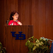Soo-Kyung Lee speaking from a podium during Spotlight Symposi Series. 