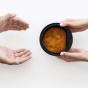 Handing off a bowl of soup. 