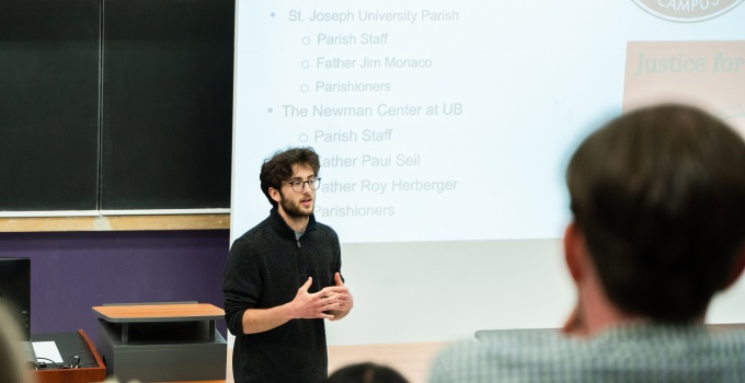Thomas Dias (PPE, Class of 2024) of the UB Parish Partners presents the results of their PPE in Practice Capstone Project to an audience of UB faculty and staff, community members, and other stakeholders on May 10, 2024.