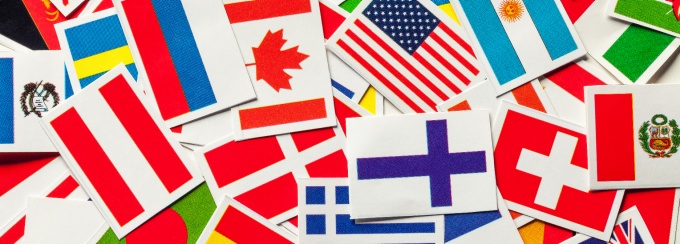 National flags of the different countries of the world are scattered in a pile. 