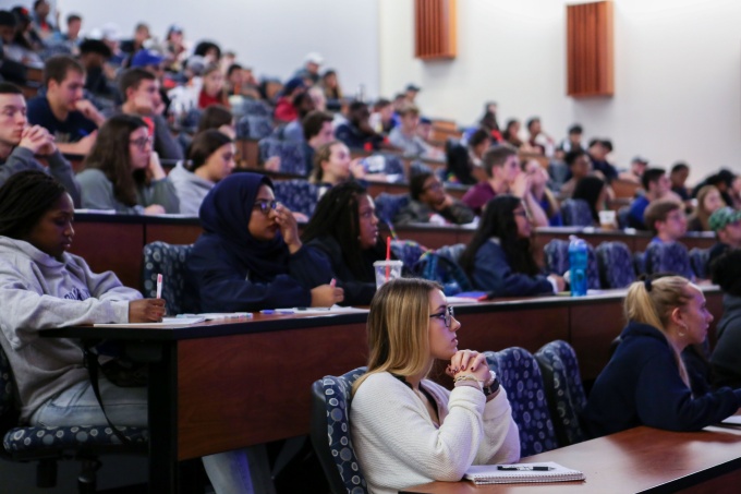 Students gathered in a lecture hall. 