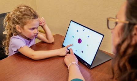 Child pointing at computer screen in Dr. Federica Bulgarelli's lab.