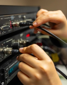Students calibrating equipment in Dr. Micheal Dent's psychoacoustics lab. 