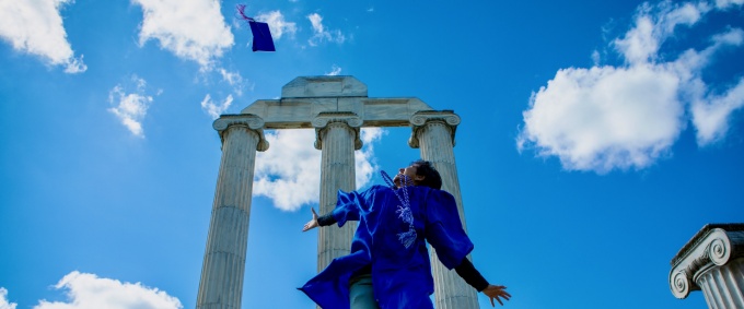 A graduate tossing their mortar board. 