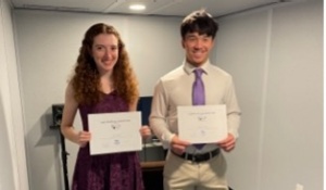 Internship participants holding awards.