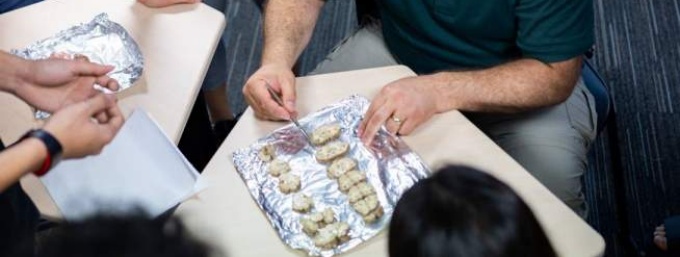 UB Sim pic of Scott Wersinger with students and brains. 
