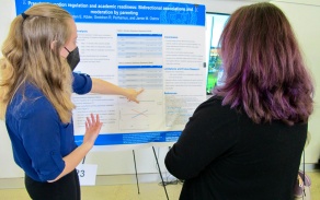 Psi Chi Officer Kristen Kibler presenting her poster to a faculty judge at the 3rd annual Western New York Undergraduate Psychology Conference. 