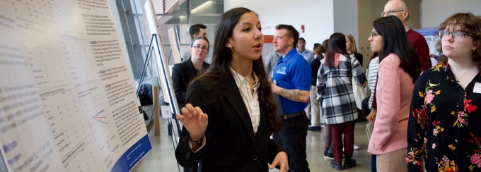 A student presenting her poster during the conference. 