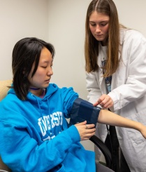 Seery Lab research assistant applying blood pressure cuff to participant. 