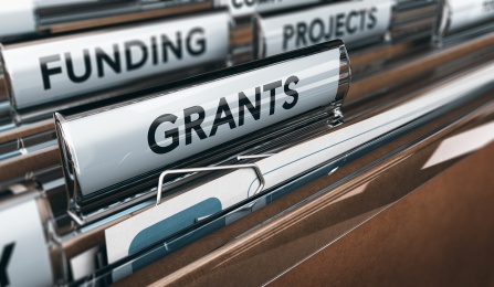 file folders labeled funding and grants. 
