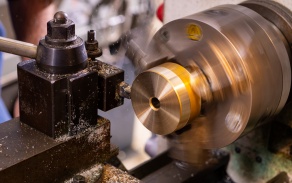 Zoom image: Precision turning being performed on a lathe. 