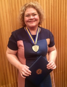 Amy Graves Monroe holding award. 