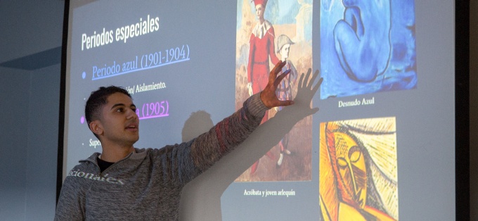 Student explains painting in Age of Lorca class. 