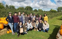 Sociology graduate students and faculty apple picking. 