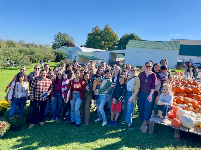 Group of students and professors on a pumpkin farm. 