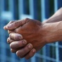 hands through jail cell bars. 