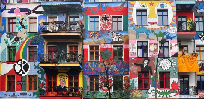 View of townhouses with colorful murals. 