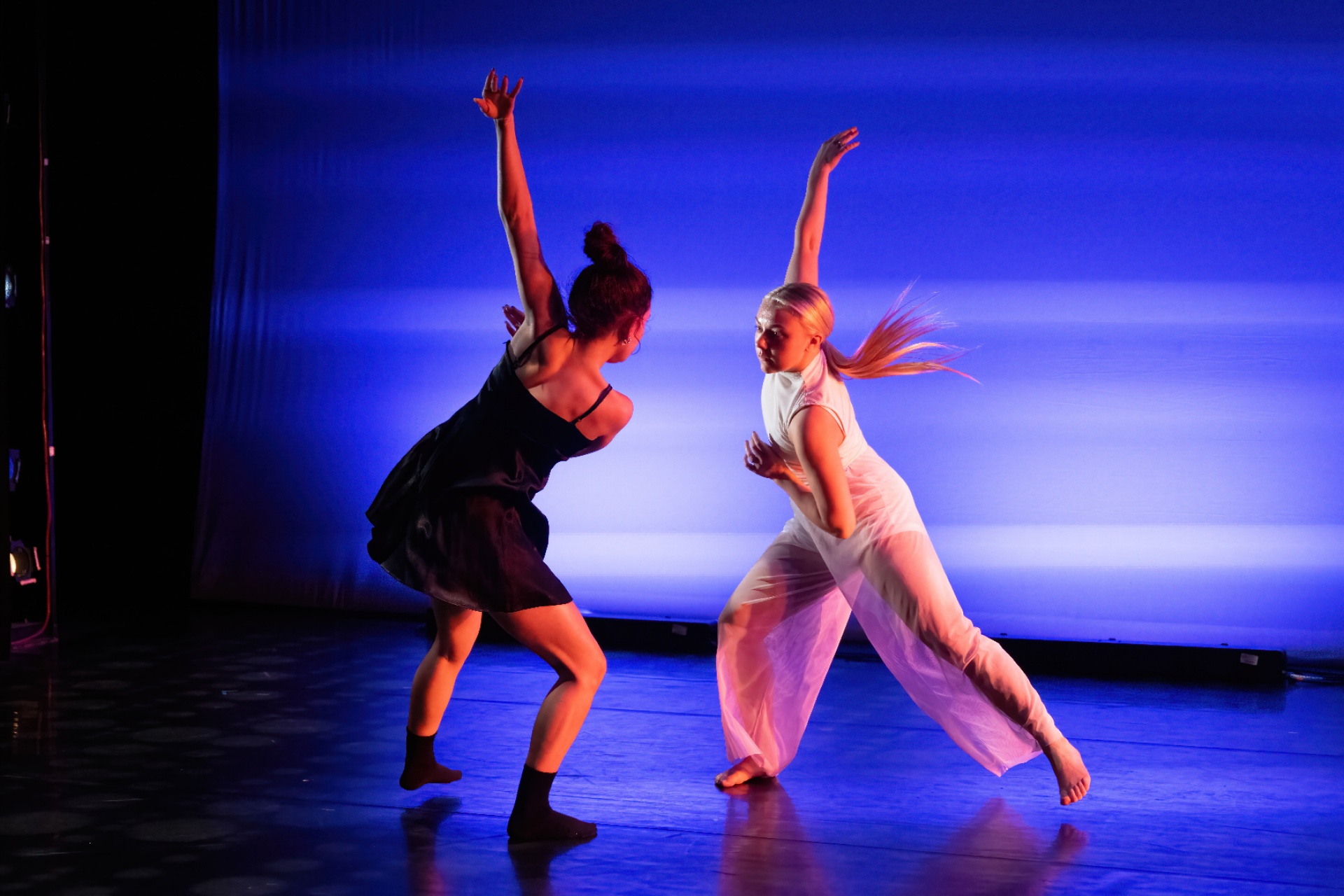 two female students on stage. 