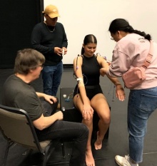 Dancer being hooked up to sensors. 