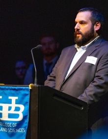 Professor Jon Shimon at a podium. 