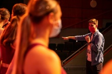 Book cover with dancers and performances on stage. 