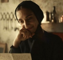 Still from "Cabrini" - actress dressed an nun reads a letter. 