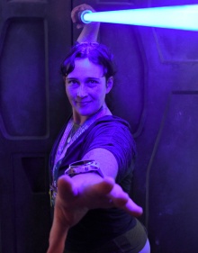 Professor Rosvally holding a Star Wars lightsabre. 