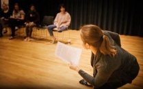 teacher in a classroom with theatre students. 